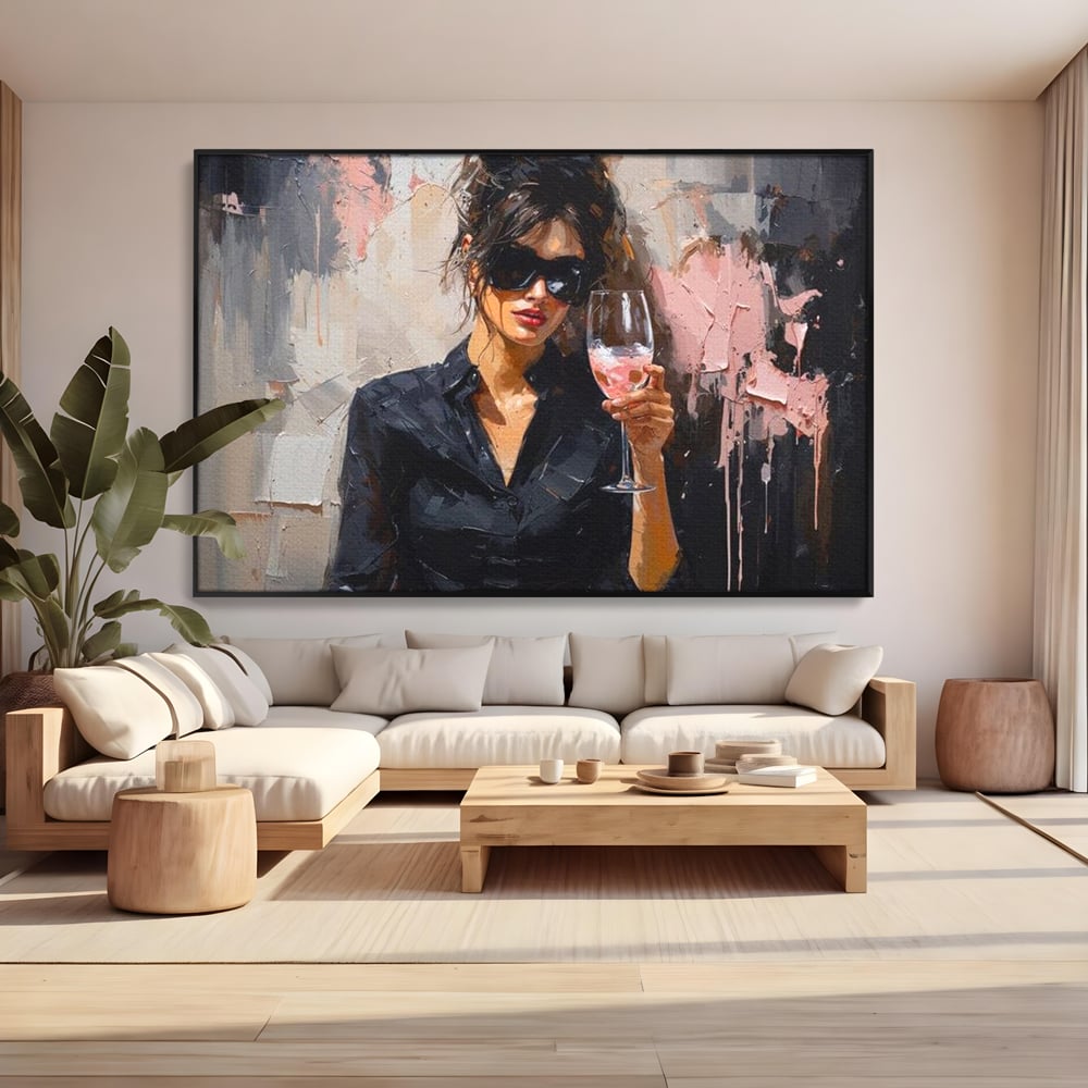 Tablou canvas cu tablou canvas cu femeie si pahar de vin, in rama de aluminiu negru, pe perete intr-un living